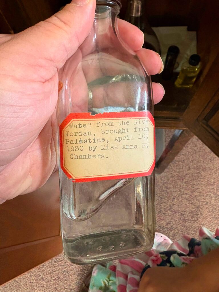 Empty Glass bottle with label that reads from the River Jordan 1930